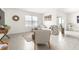 Bright living room featuring tile flooring, neutral walls, large window, and comfortable seating at 9098 Forge Breeze Loop, Wesley Chapel, FL 33545