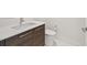 Bathroom vanity featuring wood cabinets, white countertops, a chrome faucet, and a modern white toilet at 100 1St N Ave # 2304, St Petersburg, FL 33701