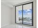 Sunny bedroom featuring a sliding glass door, balcony, and fantastic view of the marina at 100 1St N Ave # 2304, St Petersburg, FL 33701