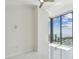 Bright bedroom featuring marble floors, ceiling fan, and floor-to-ceiling windows with beautiful ocean views at 100 1St N Ave # 2304, St Petersburg, FL 33701