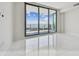 Bright bedroom featuring floor to ceiling glass doors leading to a private balcony and white tile floors at 100 1St N Ave # 2304, St Petersburg, FL 33701