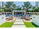 Inviting outdoor lounge area featuring comfortable seating, a pergola, and lush landscaping, perfect for relaxing at 100 1St N Ave # 2304, St Petersburg, FL 33701
