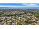 A neighborhood aerial with ponds and mature trees featuring a distant view of the ocean at 1000 Chatham Ct, Safety Harbor, FL 34695