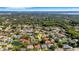 Aerial view of a sprawling residential community with mature trees and manicured landscapes at 1000 Chatham Ct, Safety Harbor, FL 34695