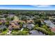 Aerial view of the property showcasing its location amidst mature trees, landscaping, and established neighborhood at 1000 Chatham Ct, Safety Harbor, FL 34695