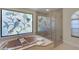 Bathroom featuring a soaking tub beneath a decorative stained glass window and a glass-enclosed shower at 1000 Chatham Ct, Safety Harbor, FL 34695