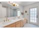 Bright bathroom featuring a double vanity, modern fixtures, and a glass-enclosed shower at 1000 Chatham Ct, Safety Harbor, FL 34695