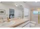 Bathroom featuring dual sinks, a large mirror and gold hardware, with a glass-enclosed shower at 1000 Chatham Ct, Safety Harbor, FL 34695