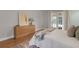 Bright bedroom with a modern dresser and French doors leading to an outdoor view at 1000 Chatham Ct, Safety Harbor, FL 34695