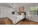 Comfortable bedroom with hardwood floors, an accent rug and bright windows at 1000 Chatham Ct, Safety Harbor, FL 34695