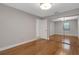 Neutral-toned bedroom with hardwood floors and a mirrored closet, bathed in natural light at 1000 Chatham Ct, Safety Harbor, FL 34695