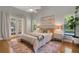 Cozy bedroom featuring hardwood floors and french doors leading to the outdoor at 1000 Chatham Ct, Safety Harbor, FL 34695