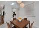 Bright dining area featuring modern lighting fixture, white walls and tile floors at 1000 Chatham Ct, Safety Harbor, FL 34695