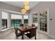 Inviting dining area with a large window view of the sparkling pool and outdoor space at 1000 Chatham Ct, Safety Harbor, FL 34695