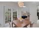 Relaxing dining area showcasing access to a kitchen and backyard through french doors at 1000 Chatham Ct, Safety Harbor, FL 34695