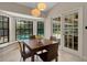 Cozy dining area with tile floors and a view of the pool, enhanced by natural light at 1000 Chatham Ct, Safety Harbor, FL 34695