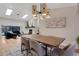 Open-concept dining area with wood table, seating, and views to the living area and fireplace at 1000 Chatham Ct, Safety Harbor, FL 34695