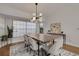 Elegant dining room with modern chandelier, wooden table, and comfortable seating at 1000 Chatham Ct, Safety Harbor, FL 34695
