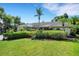 Well-maintained home with vibrant green lawn and mature hedges providing privacy and curb appeal at 1000 Chatham Ct, Safety Harbor, FL 34695