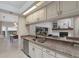 Well-lit kitchen featuring granite countertops, white cabinets, stainless steel appliances, and an open layout at 1000 Chatham Ct, Safety Harbor, FL 34695