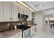 Bright kitchen features stainless steel appliances, granite countertops, and white cabinets at 1000 Chatham Ct, Safety Harbor, FL 34695