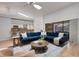 Sunlit living area with hardwood flooring, modern furniture, and sliding glass doors leading to outdoor pool at 1000 Chatham Ct, Safety Harbor, FL 34695
