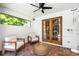 Relaxing outdoor patio with comfortable seating, a wicker ottoman, and view of a well-landscaped backyard at 1000 Chatham Ct, Safety Harbor, FL 34695