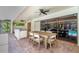Covered patio featuring an outdoor kitchen and a dining area overlooking the pool and screened enclosure at 1000 Chatham Ct, Safety Harbor, FL 34695