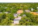 Aerial view capturing surrounding trees, neighborhood homes, and the property's rooftop at 1011 S Moody Ave # 11, Tampa, FL 33629
