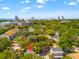 Aerial view showcases the property and the surrounding neighborhood, with city skyline in the distance at 1011 S Moody Ave # 11, Tampa, FL 33629
