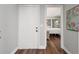 View of the entryway revealing the bedroom with mirrored closet doors and hardwood floors at 1011 S Moody Ave # 11, Tampa, FL 33629
