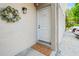 Exterior view of the front door with seasonal wreath and exterior lighting at 1011 S Moody Ave # 11, Tampa, FL 33629