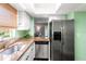 Well-lit kitchen boasts stainless steel appliances and a view into the living room at 1011 S Moody Ave # 11, Tampa, FL 33629