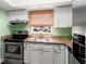 Bright kitchen features stainless steel appliances, granite counters and white cabinets at 1011 S Moody Ave # 11, Tampa, FL 33629