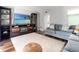 Comfortable living area with entertainment center, stylish sofa, and a view of the kitchen at 1011 S Moody Ave # 11, Tampa, FL 33629