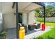 Relaxing patio area with outdoor seating and a view of the green lawn at 1011 S Moody Ave # 11, Tampa, FL 33629