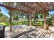 Relax on the patio with a hanging chair, lush landscaping and lake views in the backyard at 10730 52Nd N Ave, St Petersburg, FL 33708