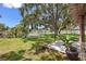 Beautiful backyard features mature trees, green grass, and water access for outdoor enjoyment at 10730 52Nd N Ave, St Petersburg, FL 33708