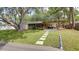 Beautiful backyard with a stone walkway and a covered patio, perfect for outdoor entertaining at 10730 52Nd N Ave, St Petersburg, FL 33708