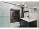 Stylish bathroom featuring a sleek black vanity and a glass-enclosed shower with decorative tile at 10730 52Nd N Ave, St Petersburg, FL 33708