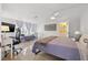 Bright primary bedroom features a ceiling fan, ensuite bathroom, and neutral decor at 10730 52Nd N Ave, St Petersburg, FL 33708