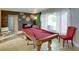 Well-appointed game room featuring a billiard table, stylish decor, and ample natural light at 10730 52Nd N Ave, St Petersburg, FL 33708
