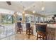 Bright kitchen boasts bar seating, pendant lighting, and views of the outdoor pool area at 10730 52Nd N Ave, St Petersburg, FL 33708
