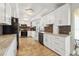 Updated kitchen with tile flooring, quartz counters, stainless appliances, and mosaic backsplash at 10730 52Nd N Ave, St Petersburg, FL 33708