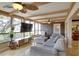 Bright living room featuring large windows, tile floors, a comfortable sofa and a decorative accent wall at 10730 52Nd N Ave, St Petersburg, FL 33708