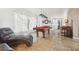 Large living area features a pool table, leather couch, and a piano at 10730 52Nd N Ave, St Petersburg, FL 33708