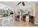 Open-concept living area with bar seating, tile floors, and a view of the pool at 10730 52Nd N Ave, St Petersburg, FL 33708