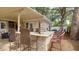 Outdoor kitchen featuring a stone countertop and bar seating, perfect for al fresco dining and entertainment at 10730 52Nd N Ave, St Petersburg, FL 33708