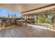Inviting patio with covered seating areas, a bar, and views of the lush backyard and pool at 10730 52Nd N Ave, St Petersburg, FL 33708