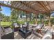 Relaxing covered outdoor patio area with comfortable seating, lush landscaping, and tranquil water views at 10730 52Nd N Ave, St Petersburg, FL 33708